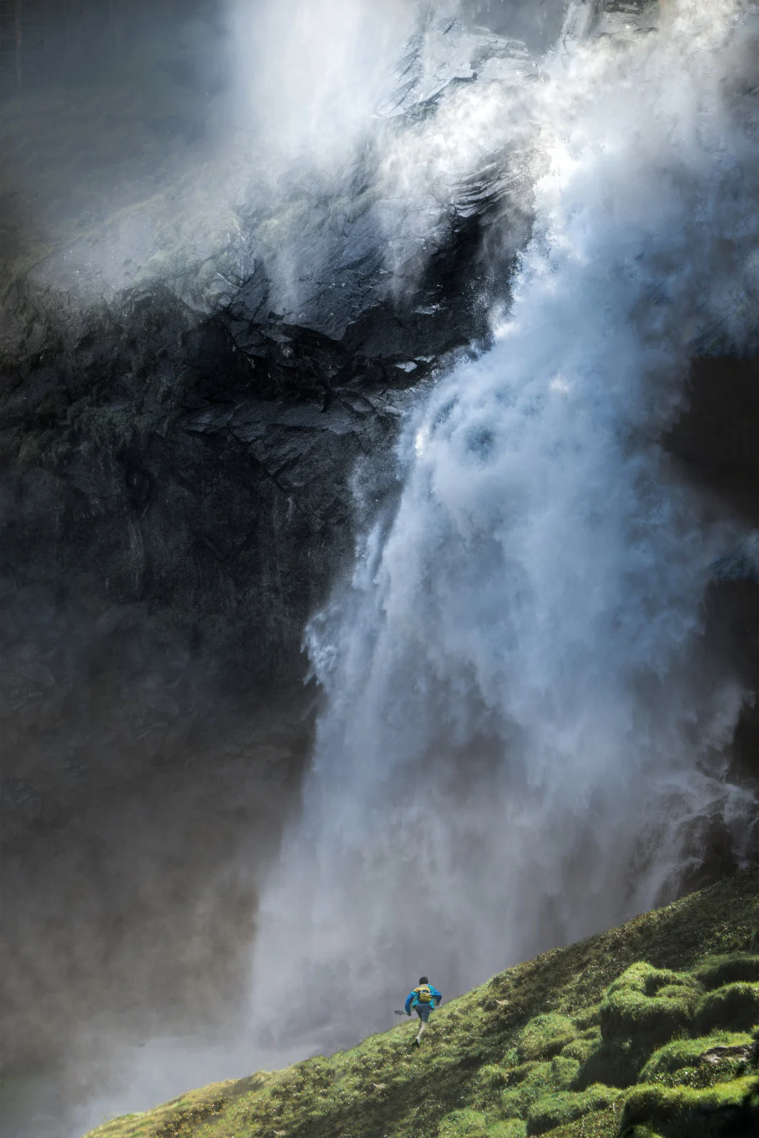 Wasserfall stürzt zwischen Felsen und leuchtend grünem Moos hinab